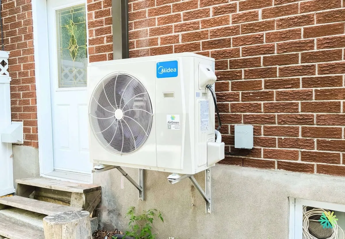HVAC technician performing a maintenance tune-up on an air conditioner