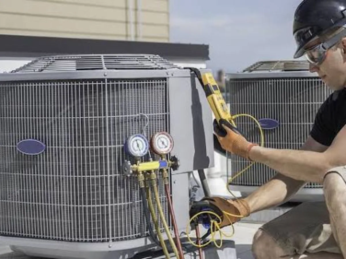 Outdoor air conditioner condenser unit beside a home