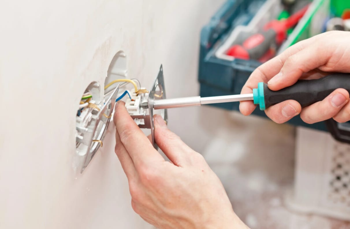 Licensed electrician working safely inside a home electrical panel