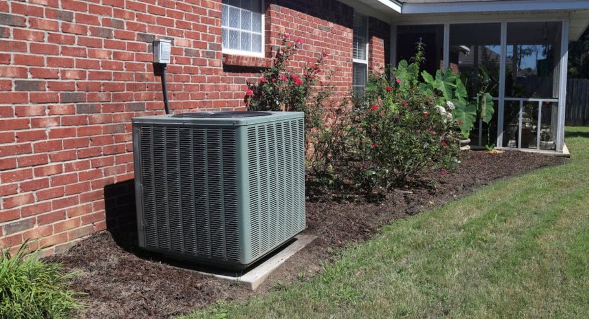 Residential HVAC system outside a brick home