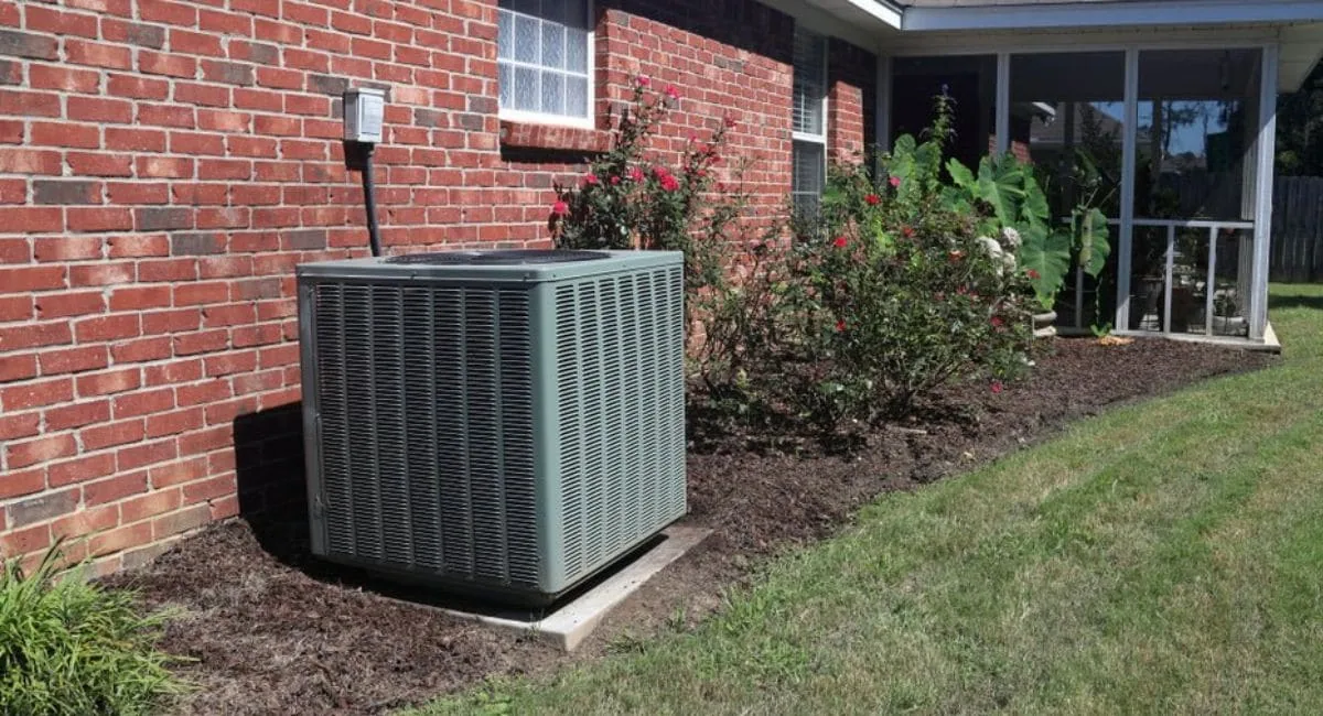 Residential HVAC system outside a brick home