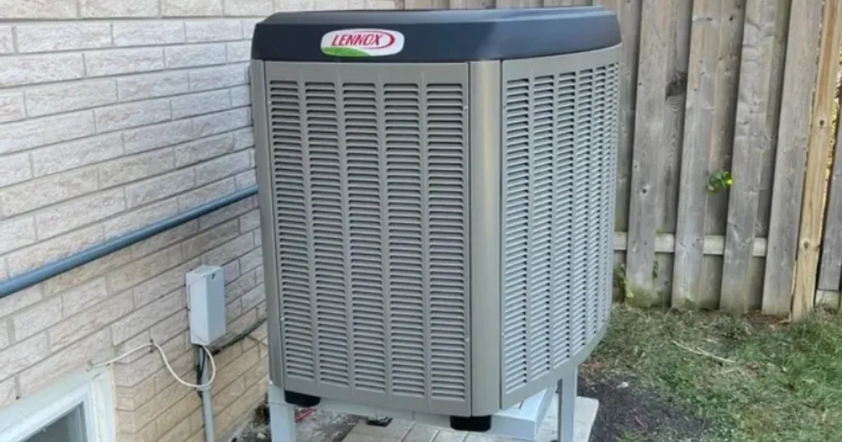 Outdoor heat pump unit beside a home