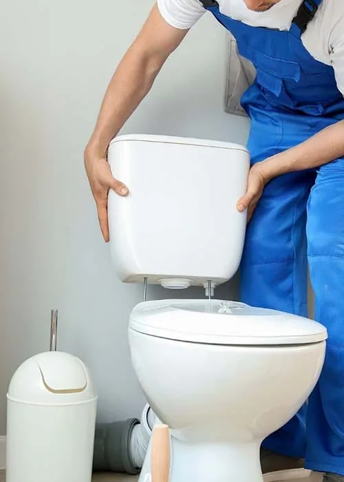 Plumber installing a new toilet during a home plumbing upgrade