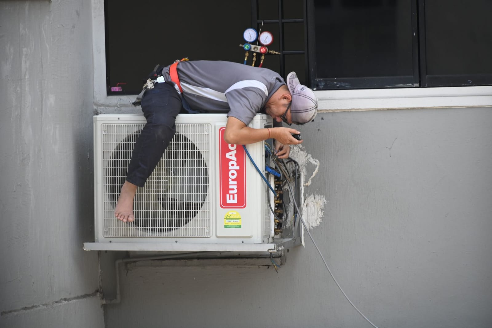 HVAC technician inspecting an air conditioner