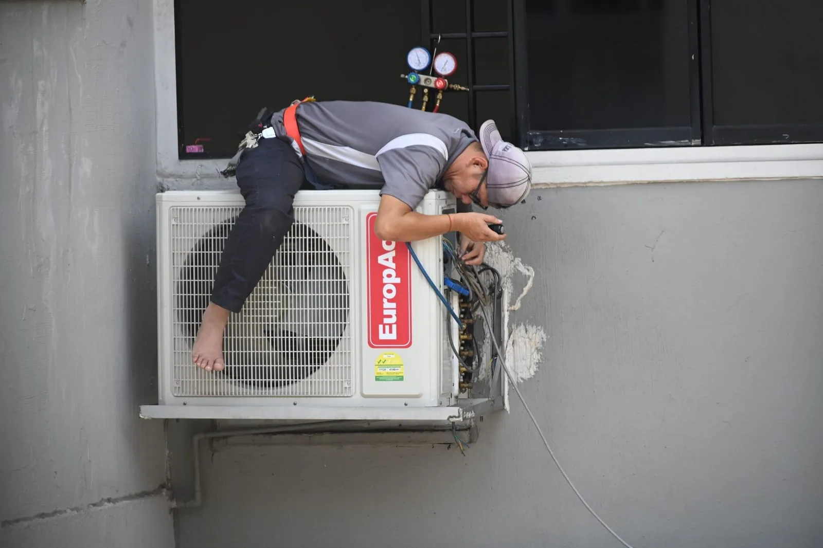 HVAC technician inspecting an air conditioner
