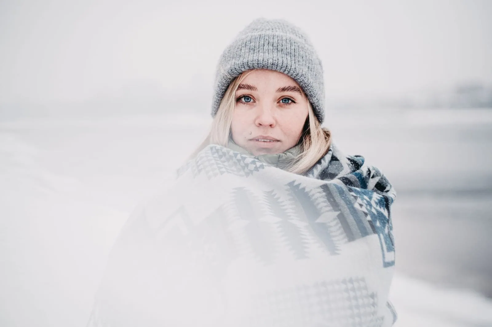 Person wrapped in a blanket staying warm at home