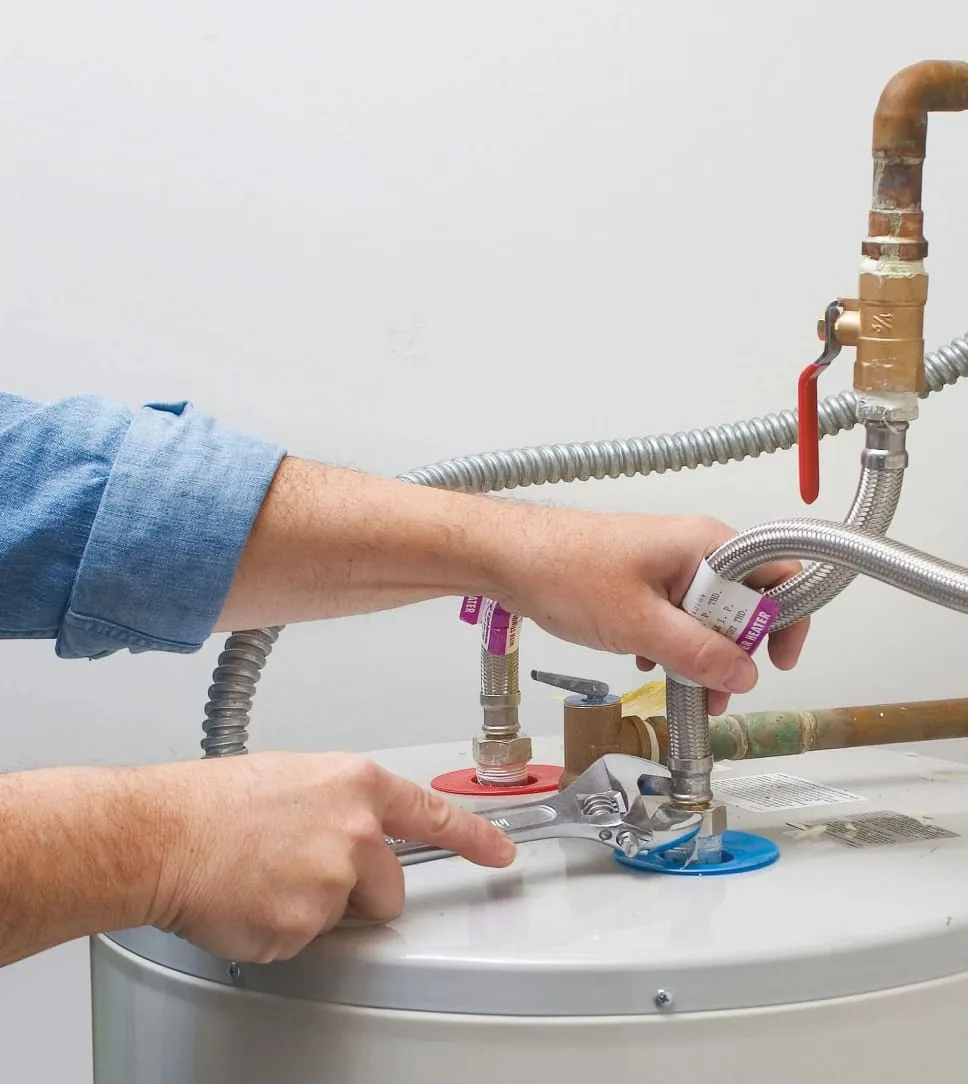 Water heater with insulated pipes in a basement during winter