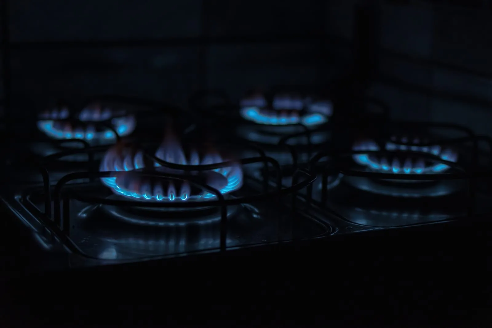 Blue flame burning on a gas stove burner